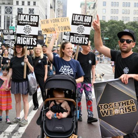 People marching and holding up signs. 