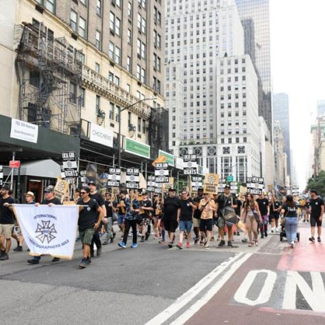 People marching and holding up signs. 