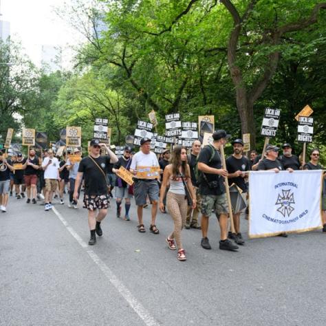 People marching and holding up signs. 