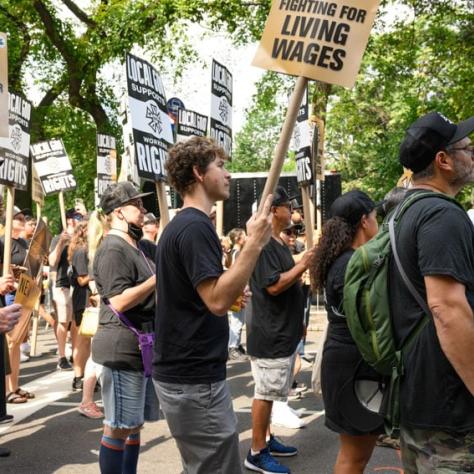 People marching and holding up signs. 