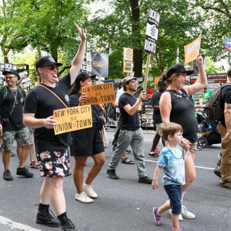 People marching and holding up signs. 