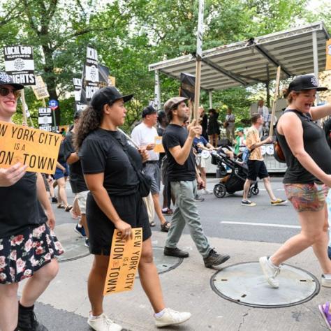 People marching and holding up signs. 