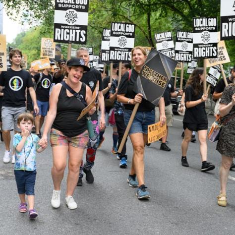 People marching and holding up signs. 