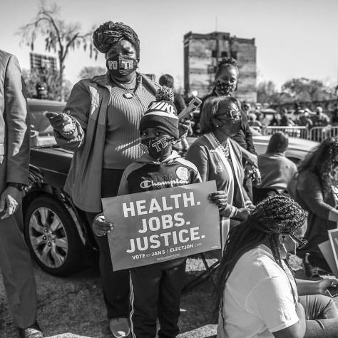 Black and white photo of people with signs. 