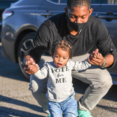 Man and child posing for photo. 