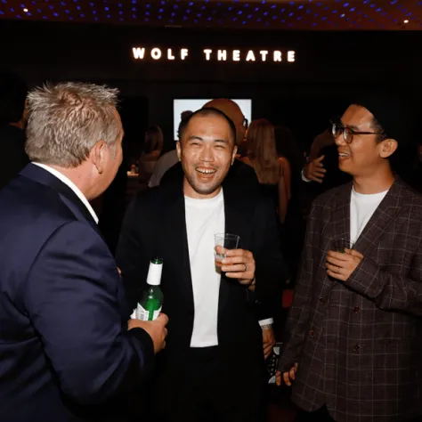 Three men smiling and laughing. 