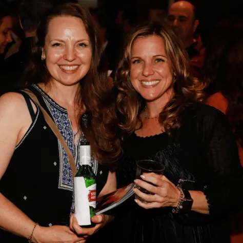 Two women smiling and posing for a photo. 