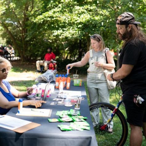 People standing at sign in table. 