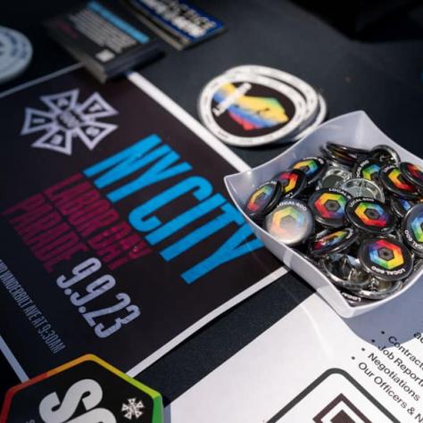 Photo of buttons and other flyers on a table. 