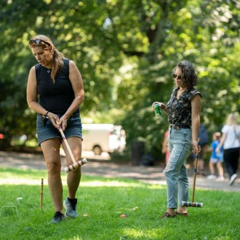 People playing croquette. 