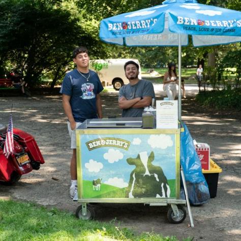 Men working at ben and jerry's stand. 