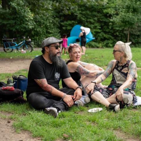 People sitting on the grass. 