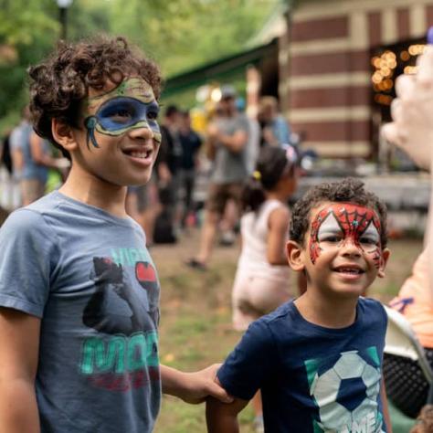 Kids posing with face paint. 