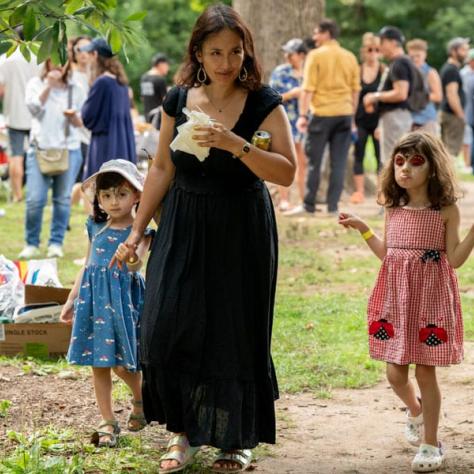 Woman and kids walking outside. 