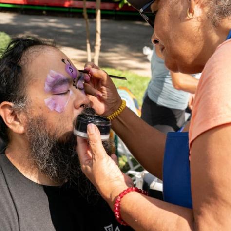 Man getting face paint. 