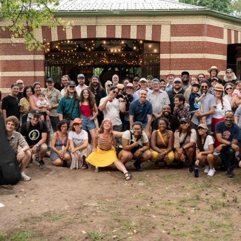 Group photo of people at event outside. 