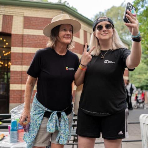 Two people taking a photo. 