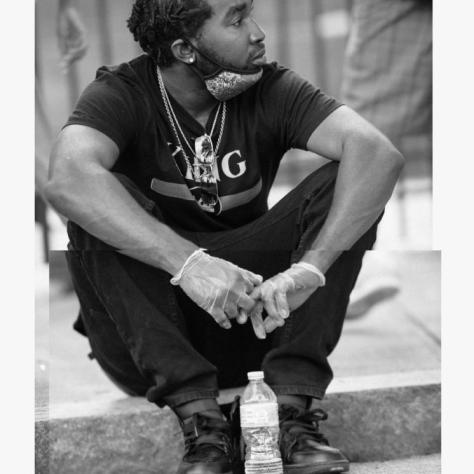 Man sitting on curb. 