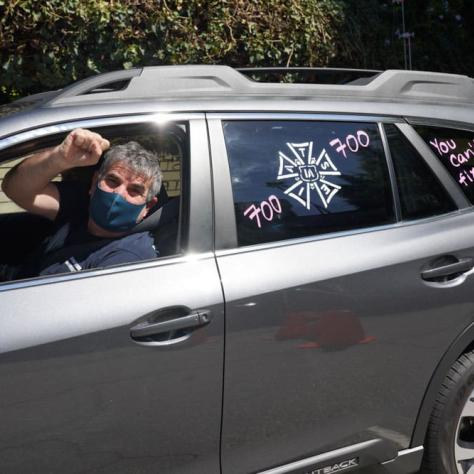 Man posing for photo with fist out the window and windows painted.