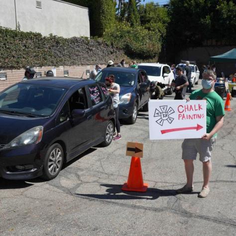 Line of cars and man with a sign.