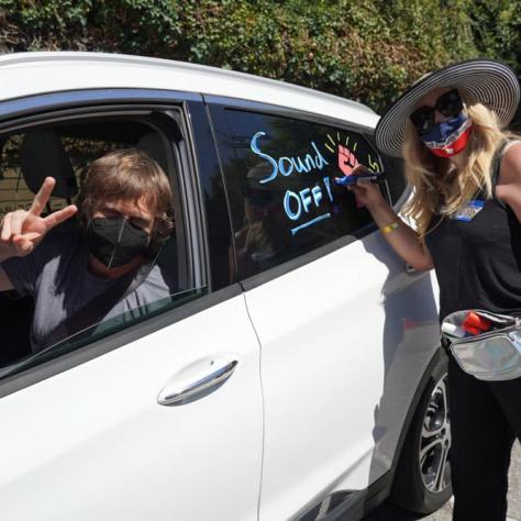 Person drawing on a car window. 