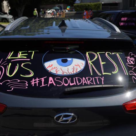 Drawing of solidarity on car window. 