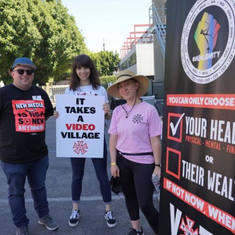 People posing with signs. 