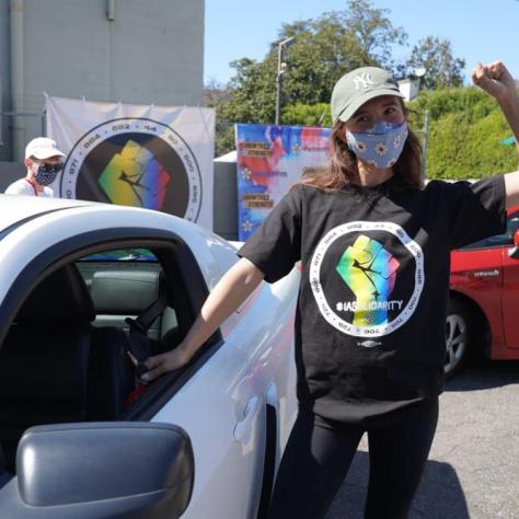 Person posing with white car. 