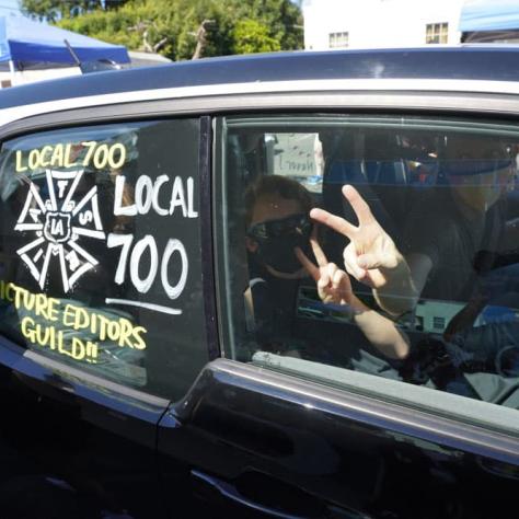 Person drawing on a car window. 