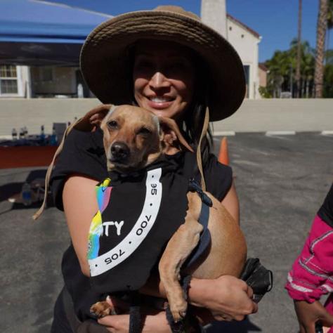 Woman posing with a dog. 