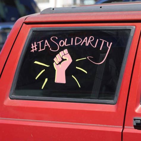 Message of solidarity on car window. 