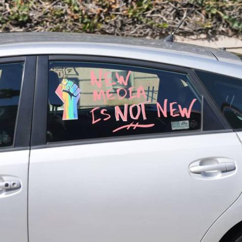 Message of solidarity on car window. 