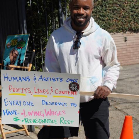 Man standing with a sign. 