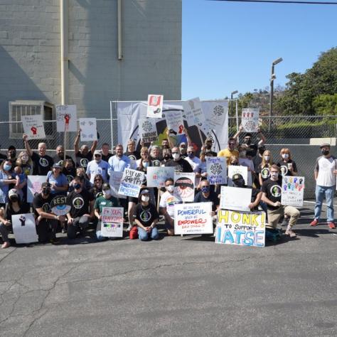 Group photo of people with signs. 