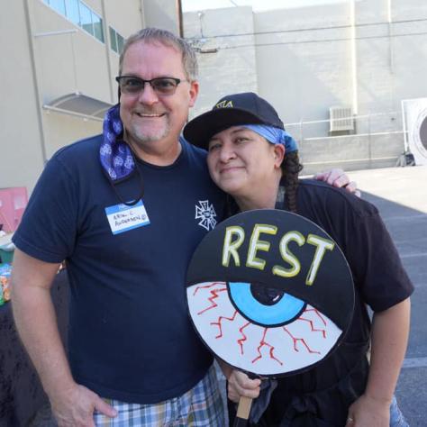 People posing for a photo together with signs. 