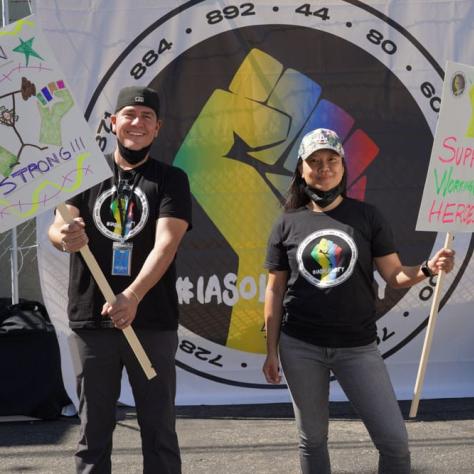 People posing with signs. 