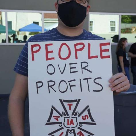 Man posing with a sign. 