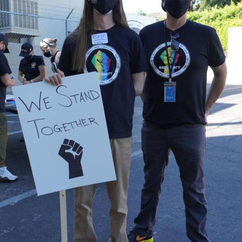 People posing with signs. 