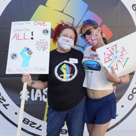 People posing with signs. 