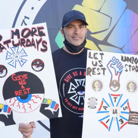 People posing with signs. 