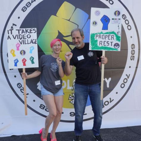 People posing with signs. 