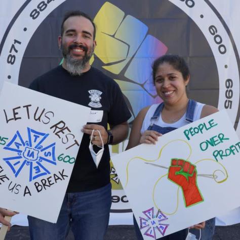 People posing with signs. 