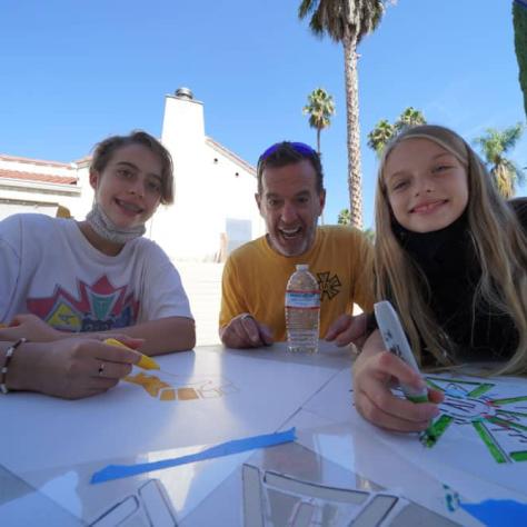 Kids making signs. 