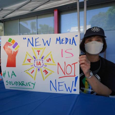 Woman holding up a sign. 