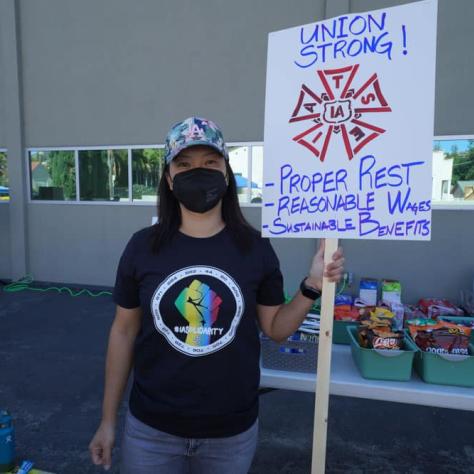 Woman posing with a sign. 