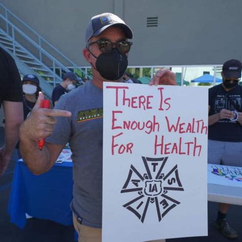 Man posing with a sign. 