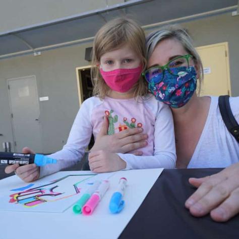 Woman and child making a sign. 