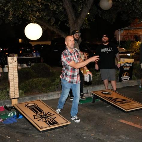 People playing cornhole.