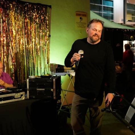 Man standing with microphone. 