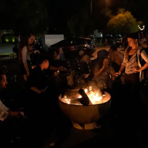 People around a fire outside. 